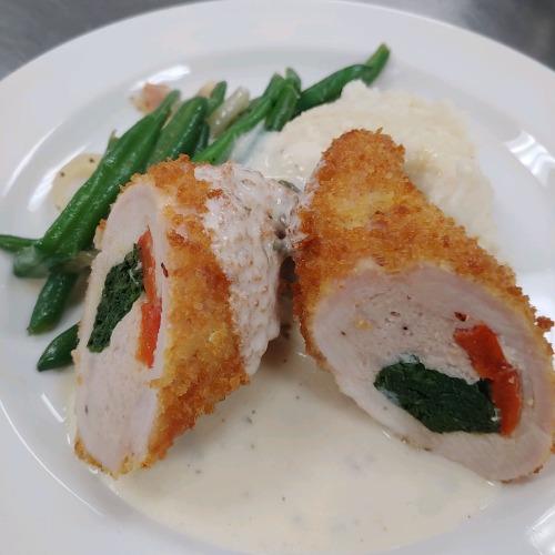 roasted red pepper and spinach stuffed chicken breast with a cream sauce