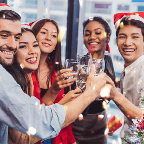 office workers with holiday drinks and decorations